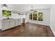 Modern, bright kitchen with gray cabinets, stainless steel appliances, and hardwood floors at 41042 Dennis Rd, Albemarle, NC 28001