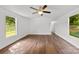 Bright living room with hardwood floors, neutral walls, and large windows for natural light at 41042 Dennis Rd, Albemarle, NC 28001