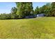Extensive green lawn, with the mobile home in the distance at 41042 Dennis Rd, Albemarle, NC 28001