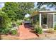 The backyard features a brick patio area with a grill, seating, and access to the sunroom at 4200 Tyndale Ave, Charlotte, NC 28210