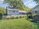Spacious backyard featuring lush green grass, manicured landscaping, and mature trees at 4200 Tyndale Ave, Charlotte, NC 28210