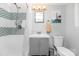 Bathroom features gray vanity and shower-tub combo at 4200 Tyndale Ave, Charlotte, NC 28210
