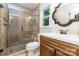Bathroom featuring glass shower, wood vanity, stone seat, and stylish fixtures at 4200 Tyndale Ave, Charlotte, NC 28210