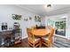 Cozy dining area with a wooden table, comfortable chairs, and natural light from the sliding glass doors at 4200 Tyndale Ave, Charlotte, NC 28210
