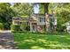Charming two-story home with a beautifully landscaped front yard and a mix of brick and siding at 4200 Tyndale Ave, Charlotte, NC 28210