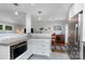 Bright and open kitchen with white cabinetry, stainless steel appliances, and a mosaic backsplash at 4200 Tyndale Ave, Charlotte, NC 28210