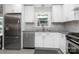Well-lit kitchen featuring stainless steel appliances, white cabinets, and modern fixtures at 4200 Tyndale Ave, Charlotte, NC 28210