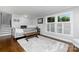 Bright living room with hardwood floors, large windows, and a cozy, neutral-toned aesthetic at 4200 Tyndale Ave, Charlotte, NC 28210
