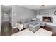Inviting living room features a fireplace, dark hardwood floors, and neutral sectional at 4200 Tyndale Ave, Charlotte, NC 28210