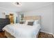 Well-lit main bedroom featuring hardwood floors, crown molding, and ensuite bathroom access at 4200 Tyndale Ave, Charlotte, NC 28210
