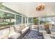Bright sunroom features a seating area and an exercise bike with views of the backyard and patio at 4200 Tyndale Ave, Charlotte, NC 28210