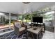 Comfortable sunroom features glass doors, tile floor, furniture, TV, and stylish rug at 4200 Tyndale Ave, Charlotte, NC 28210