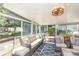 Bright sunroom with comfortable seating, a ceiling fan, and views of the outdoor patio at 4200 Tyndale Ave, Charlotte, NC 28210