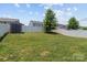Fenced backyard featuring well-maintained lawn, mature tree, and outdoor storage shed for tools and equipment at 4313 Gibbon Crossing Dr, Charlotte, NC 28269
