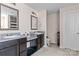 Bathroom featuring double sinks with granite countertops, dark wood cabinets, and tile flooring at 4313 Gibbon Crossing Dr, Charlotte, NC 28269