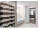 Bathroom featuring a soaking tub, shower with striped curtain, and open doorway at 4313 Gibbon Crossing Dr, Charlotte, NC 28269