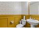 Stylish half-bathroom with geometric wallpaper, sink, and golden trim at 4313 Gibbon Crossing Dr, Charlotte, NC 28269