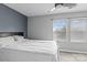 Bedroom with a queen bed, ceiling fan, and a bright window that brings in natural light at 4313 Gibbon Crossing Dr, Charlotte, NC 28269