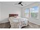 Bedroom featuring a ceiling fan, a bed with patterned bedding, and a window with blinds at 4313 Gibbon Crossing Dr, Charlotte, NC 28269