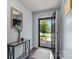 Inviting entryway with hardwood floors, stylish console table, mirror and open doorway at 4313 Gibbon Crossing Dr, Charlotte, NC 28269