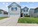 Charming two-story home featuring a gray siding, attached garage, and well-maintained landscaping at 4313 Gibbon Crossing Dr, Charlotte, NC 28269