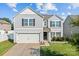 Charming two-story home featuring a gray siding, attached garage, and well-maintained landscaping at 4313 Gibbon Crossing Dr, Charlotte, NC 28269