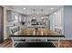 Well-lit kitchen boasts gray cabinets, stainless steel appliances, and a wooden dining table at 4313 Gibbon Crossing Dr, Charlotte, NC 28269
