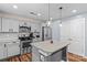 Modern kitchen features stainless steel appliances, gray cabinetry, and pendant lighting at 4313 Gibbon Crossing Dr, Charlotte, NC 28269