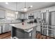 Well-lit kitchen with stainless appliances, granite countertops, and wood flooring at 4313 Gibbon Crossing Dr, Charlotte, NC 28269