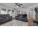 Open-concept living room showcasing wood floors, a ceiling fan, and seamless flow to the kitchen at 4313 Gibbon Crossing Dr, Charlotte, NC 28269