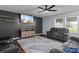 Cozy living room with dark accent wall, comfortable seating, and a ceiling fan at 4313 Gibbon Crossing Dr, Charlotte, NC 28269