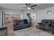 Open-concept living room showcasing wood floors, a ceiling fan, and seamless flow to the kitchen at 4313 Gibbon Crossing Dr, Charlotte, NC 28269