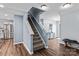 Entry staircase featuring hardwood floors and modern lighting leading to the second floor at 4313 Gibbon Crossing Dr, Charlotte, NC 28269