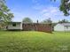 Expansive brick home backyard features lush lawn with ample space for outdoor activities and relaxation on a sunny day at 46 Donna Dale Se Ave, Concord, NC 28025
