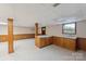 Spacious basement featuring a functional kitchenette with wood cabinets and counter space at 46 Donna Dale Se Ave, Concord, NC 28025