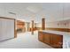 Spacious basement area with fireplace, storage cabinets, and neutral carpet for versatile use at 46 Donna Dale Se Ave, Concord, NC 28025