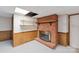 Basement fireplace with brick surround and wood mantle at 46 Donna Dale Se Ave, Concord, NC 28025
