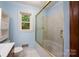 A bathroom features a tub and shower combination with white tile and sliding glass doors at 46 Donna Dale Se Ave, Concord, NC 28025