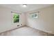 Bright bedroom featuring carpeted floors and two windows at 46 Donna Dale Se Ave, Concord, NC 28025