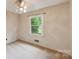 A cozy bedroom offers lots of natural light from large windows at 46 Donna Dale Se Ave, Concord, NC 28025