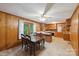 Spacious kitchen connected to a dining area with wood paneling and natural light at 46 Donna Dale Se Ave, Concord, NC 28025