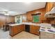 Functional kitchen with wood cabinets and laminate countertops next to dining area at 46 Donna Dale Se Ave, Concord, NC 28025