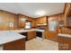 Functional kitchen with wood cabinets, laminate countertops and basic appliances at 46 Donna Dale Se Ave, Concord, NC 28025