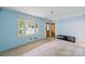 Bright living room with neutral carpet, light blue walls and a view of the front yard at 46 Donna Dale Se Ave, Concord, NC 28025