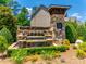 Stone waterfall sign reading 'Manors at Lake Ridge' with lush greenery and landscaping at 509 Abelia Ln, Tega Cay, SC 29708