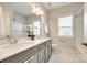 Bathroom featuring double sinks, white cabinets, modern fixtures, and tile floors at 509 Abelia Ln, Tega Cay, SC 29708