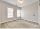 This bedroom features two windows, neutral walls, and plush carpeting at 509 Abelia Ln, Tega Cay, SC 29708