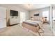 Stylishly furnished bedroom boasts a modern platform bed, TV, and sophisticated decor at 509 Abelia Ln, Tega Cay, SC 29708
