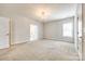 Spacious bedroom featuring a chandelier, plush carpeting, and ample natural light from a window at 509 Abelia Ln, Tega Cay, SC 29708