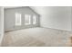 Bright bonus room with high ceilings and three windows offers ample space and natural light at 509 Abelia Ln, Tega Cay, SC 29708